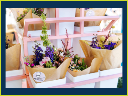 A table adorned with colorful flowers arranged in paper bags, creating a charming and vibrant display.