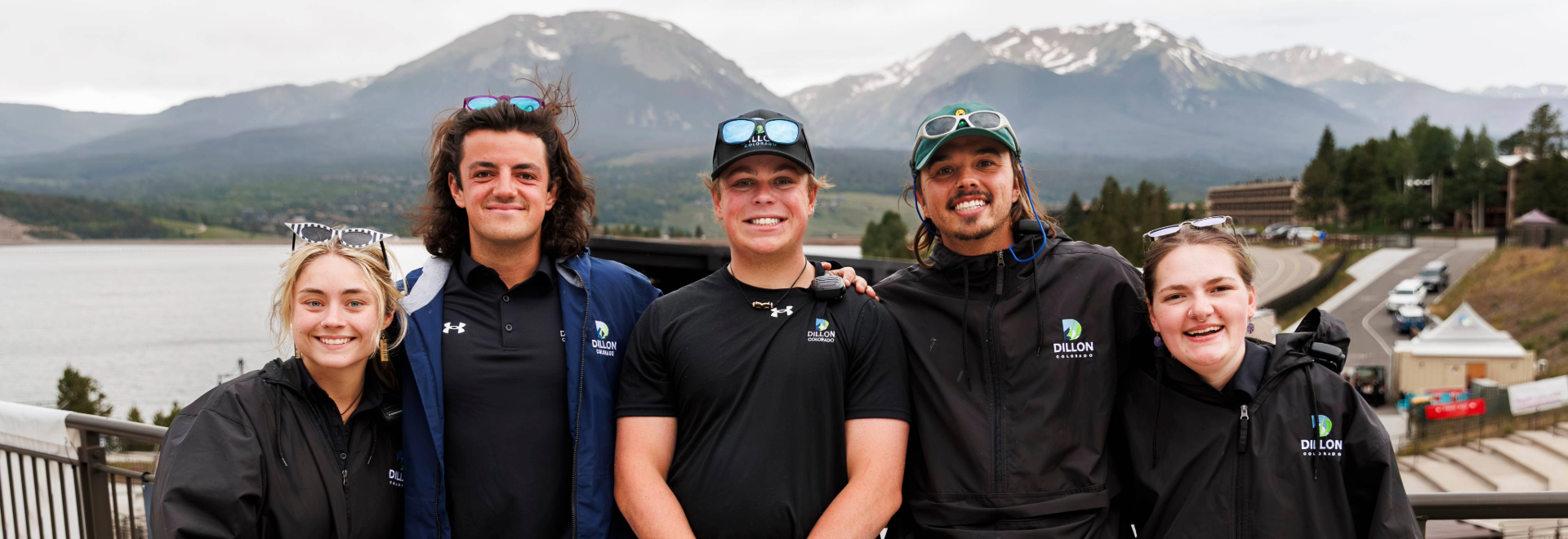 Four smiling individuals pose together for a cheerful group photo